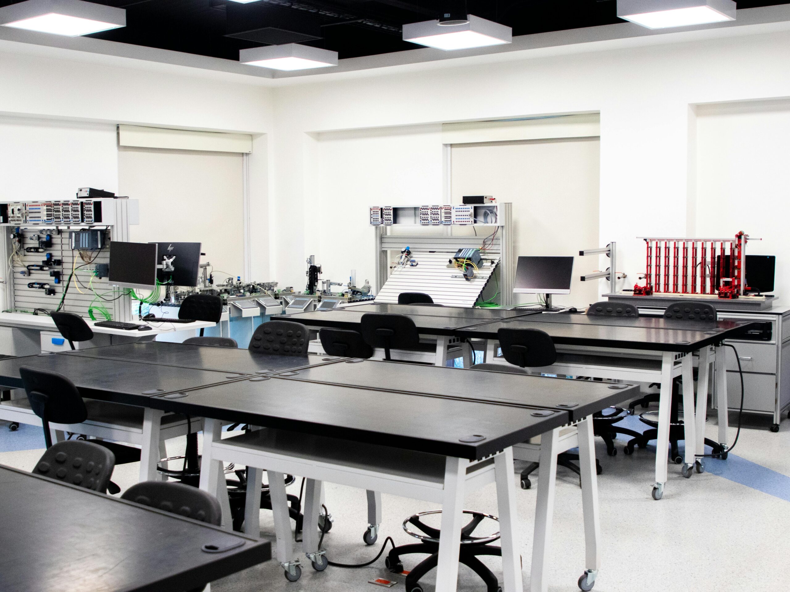 A contemporary classroom equipped with advanced technological tools and workstations.